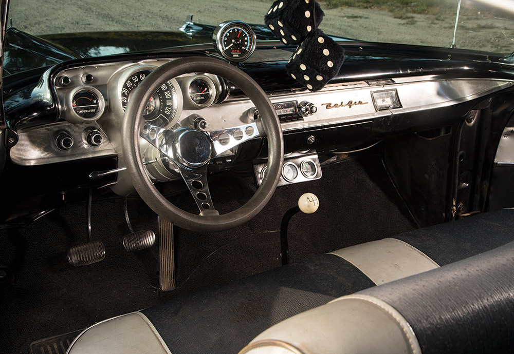 Bel-Air's dashboard and fuzzy black dice on rear view mirror