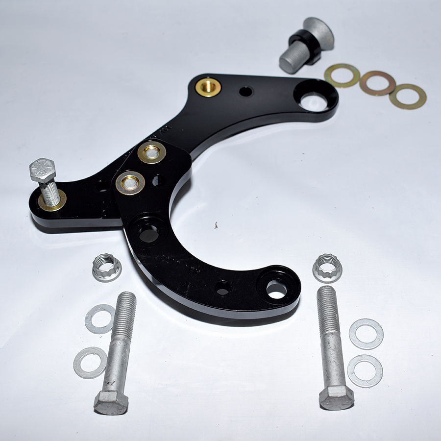 The two-piece caliper mounting brackets have dedicated locations—this is the left side bracket. Note the tapered screw (top) that requires one thick and initially three thin spacers. 