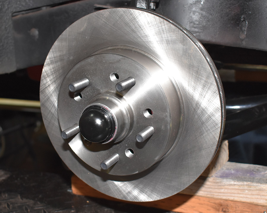 At this point, the caliper brackets are installed, verified as parallel to the rotors, the wheel bearings are adjusted, and the dust cap has been installed.
