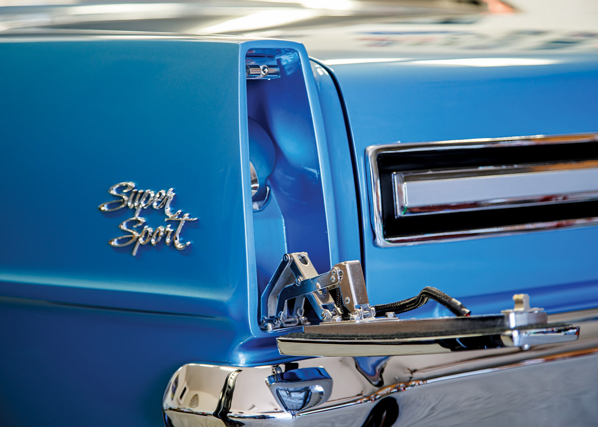 close view of the rear driver side taillight that lowers to give access to the gas tank and the rear driver side panel emblem on the ’67 Nova SS