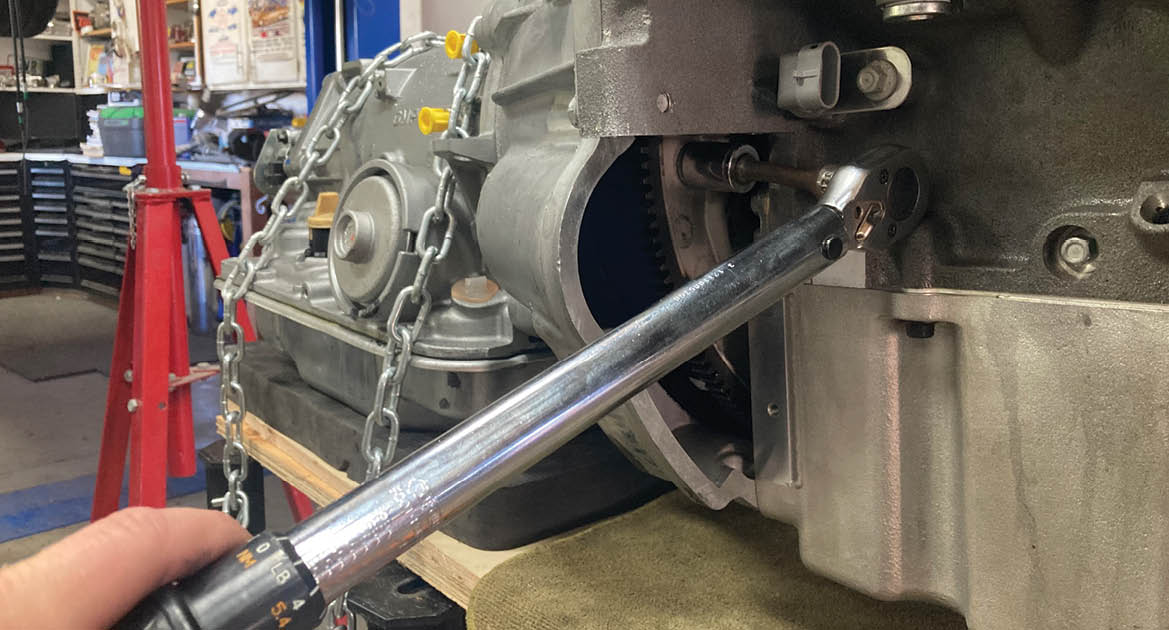 If everything is within spec, the three torque converter to flexplate fasteners are installed and torqued to 37 lb-ft.