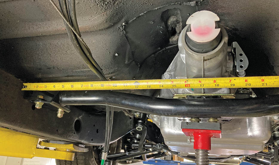 Out behind the transmission, we set our attention to the transmission mount. First, the CPP transmission crossmember is loosely attached to the transmission mount and the trans checked for center between the framerails.