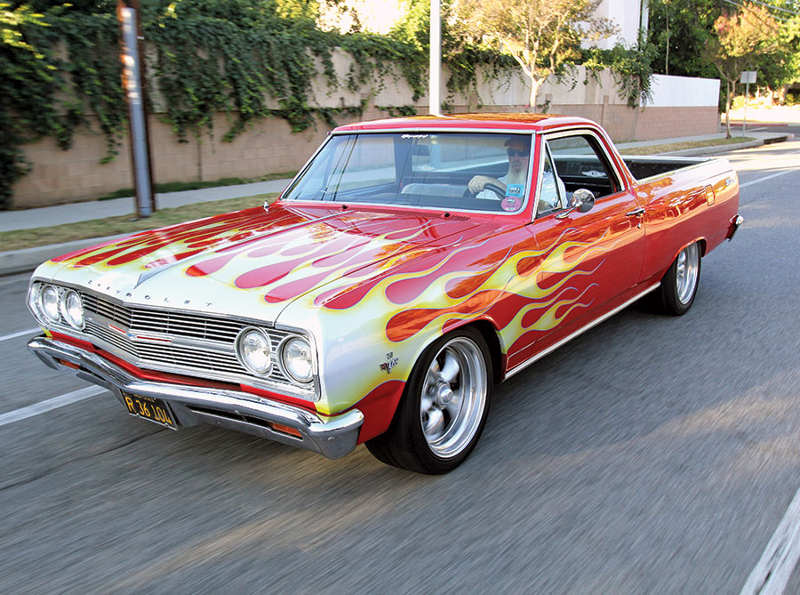 3/4 view of a red classic car with yellow flame decals