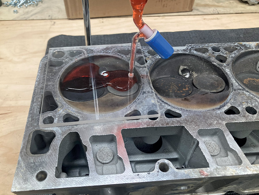 red-dyed water being poured into the combustion chamber