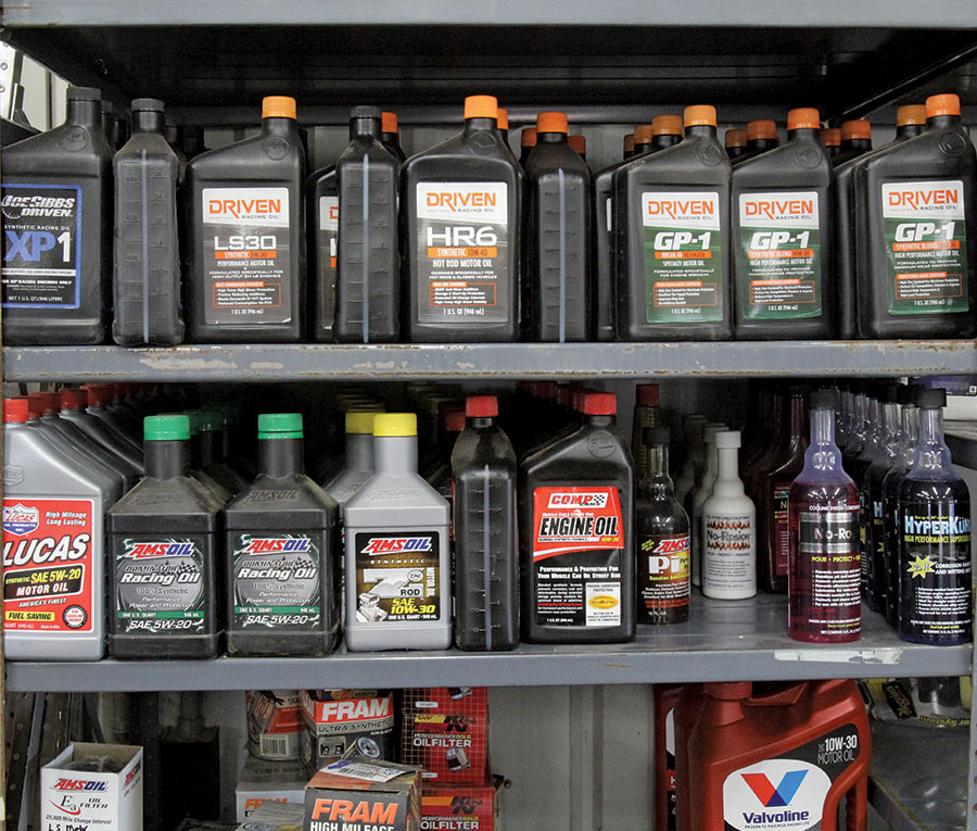 bottles of engine oil sitting on a shelf