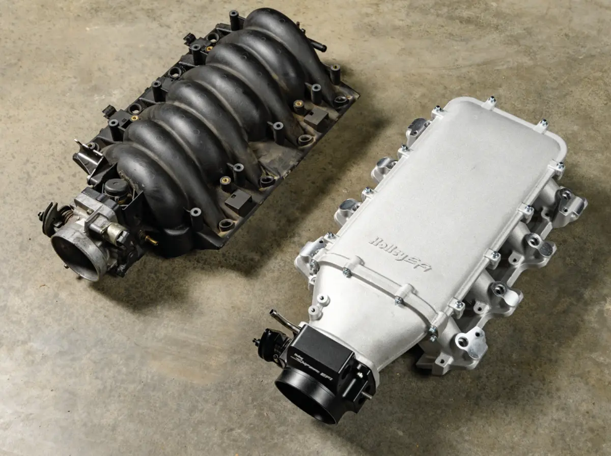 top view of the stock LS1 intake manifold placed beside the new Lo-Ram from Holley for comparison