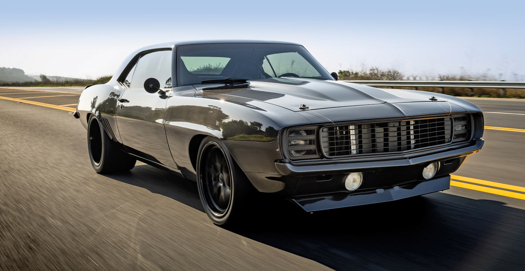 black ’69 Camaro driving on the highway