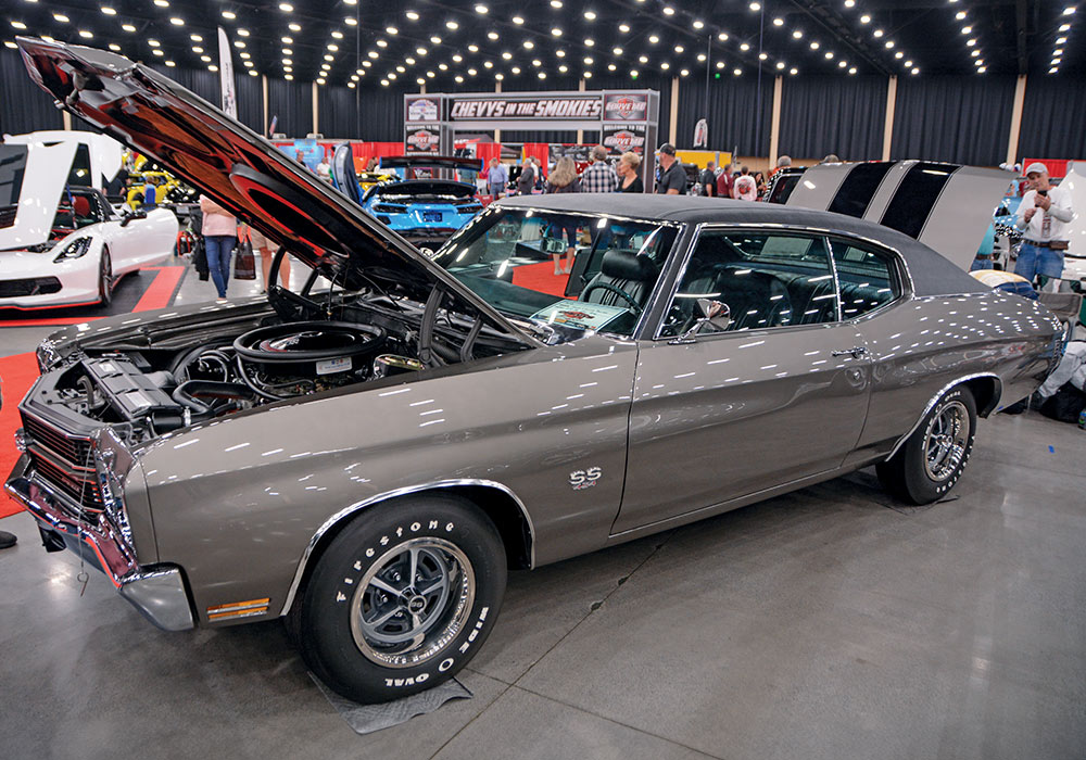 hood and trunk open on grey car with black stripe detail 