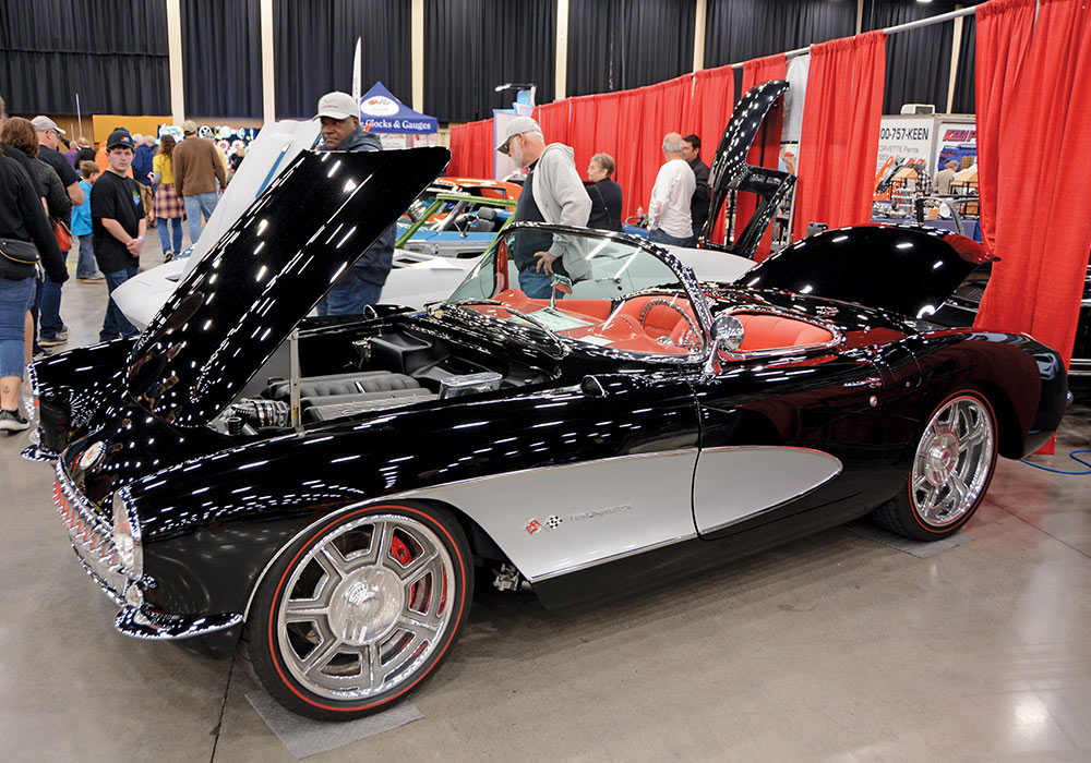 black car with white detailing and red interior parked with trunk and hood open