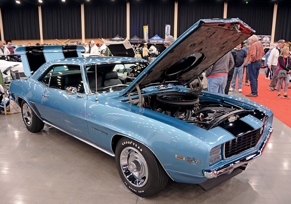 light blue car with hood open