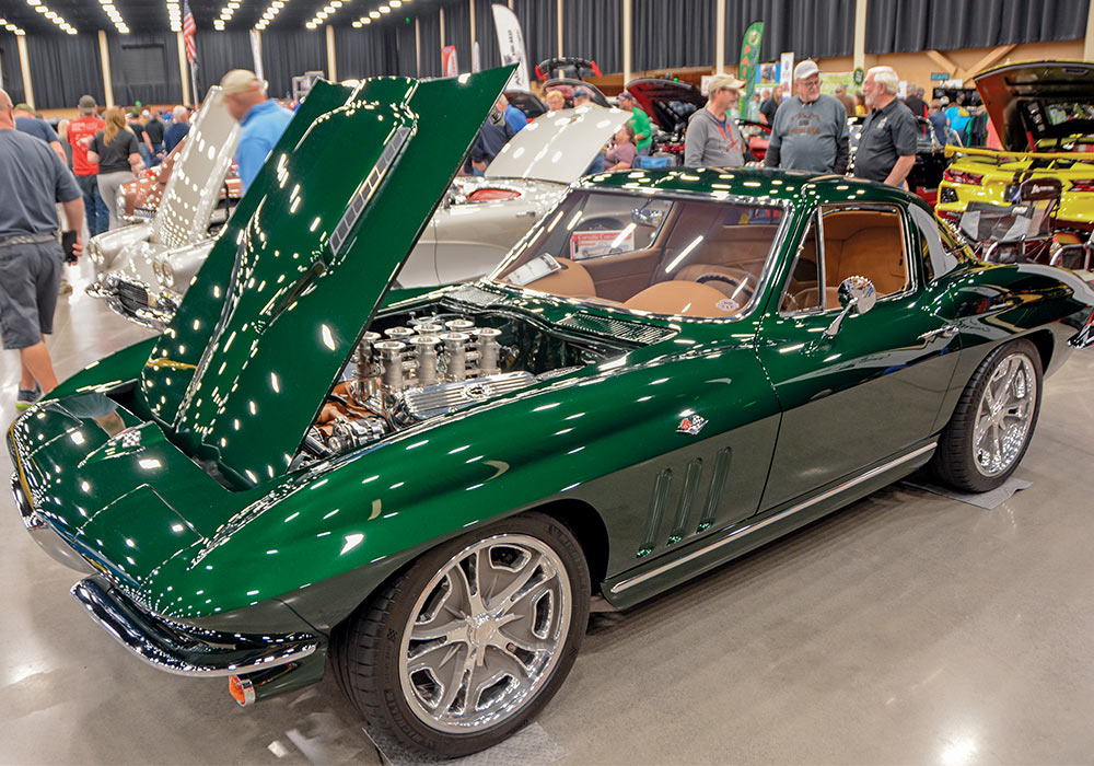 emerald green car with tan interior with hood popped open 