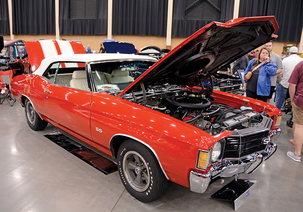 red car with white roof with hood and trunk open 