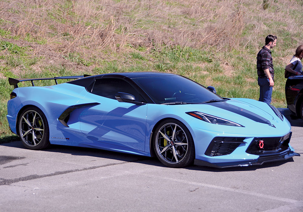 light blue car with black details parked in an outdoor setting