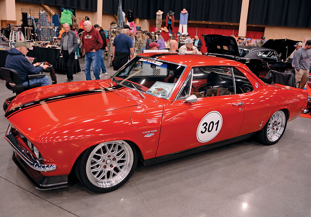 shiny red car with a black stripe and a '301' decal 
