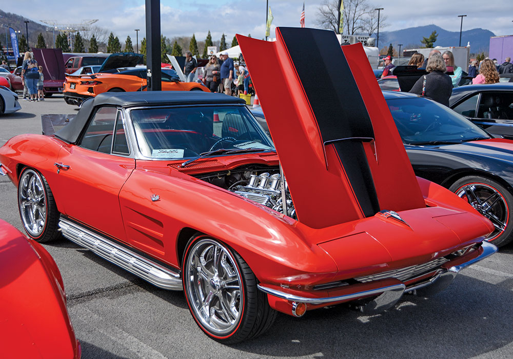 red car with black roof and black stripe detail on hood of car 
