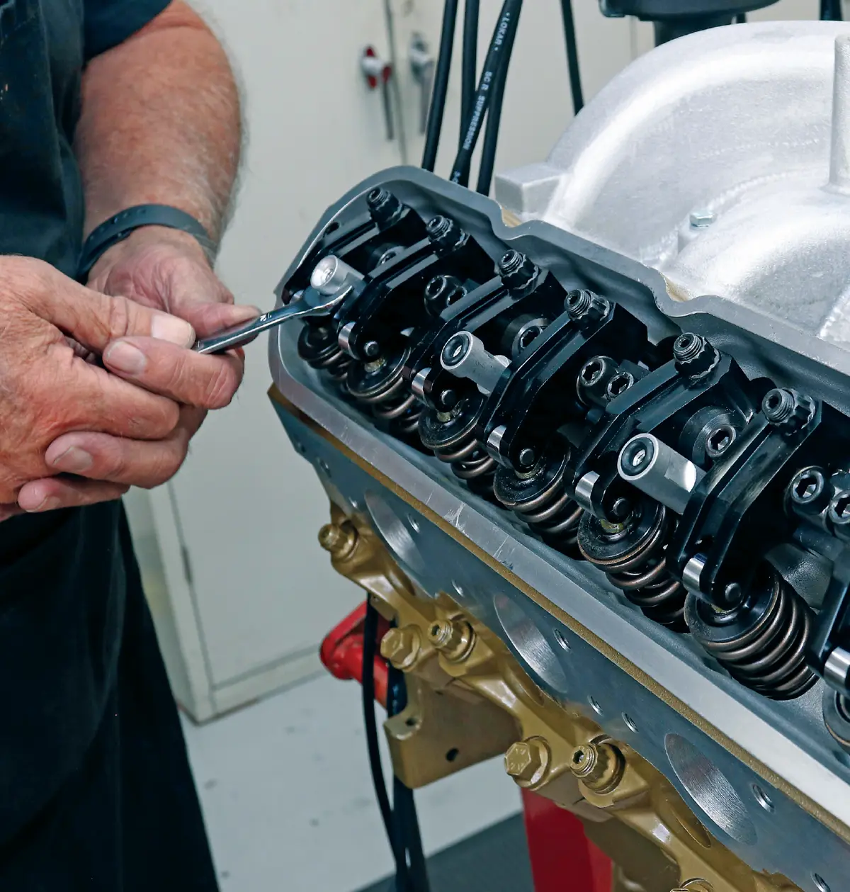 an adjustment is made to one of the valve cover's aluminum stands