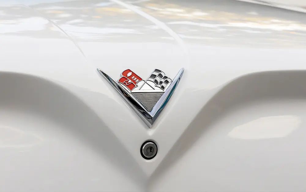 zoomed in view of the 60s Chevy Corvette emblem on the front hood of the ’61 Chevy Bel Air/Biscayne