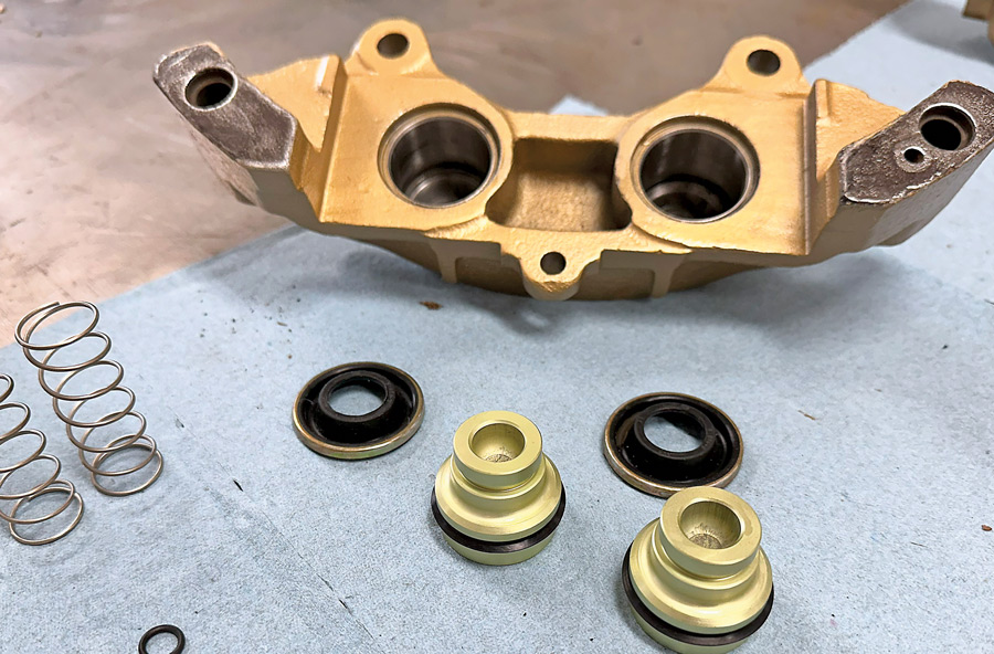 caliper next to replacement pistons