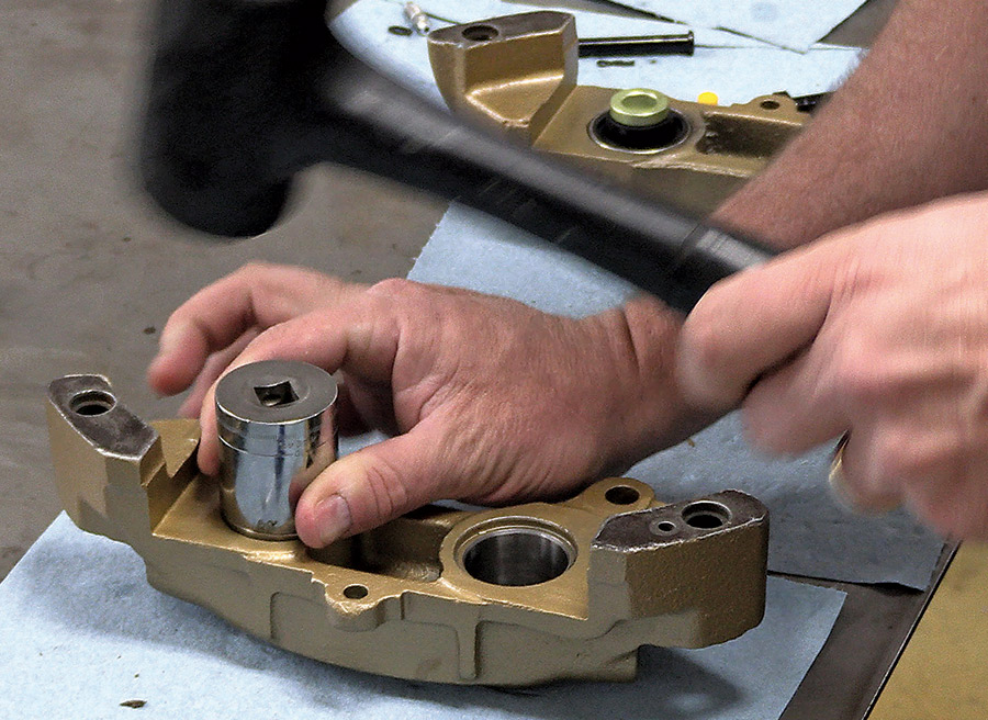 hand using socket to secure piston and bore into caliper