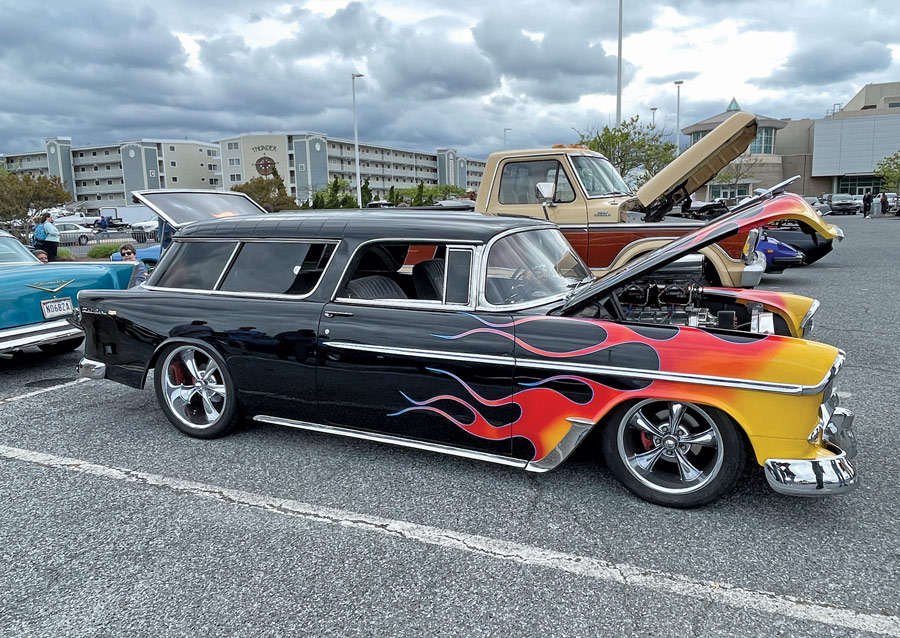 black car with hood open and flame details 