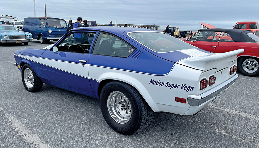 3/4 rear view of blue and white car with 'Motion Super Vega' decal 