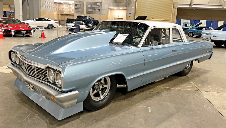 side view of light blue car with white top