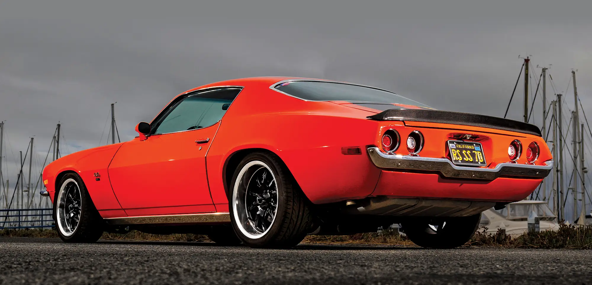 3/4 view of red-orange '70 Camaro from rear