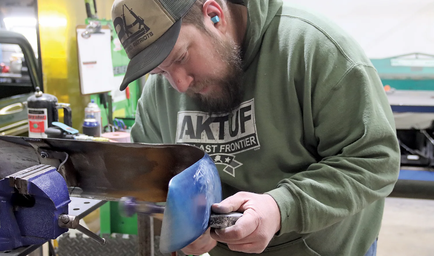 Dave Williams working on the bumpers of a 1955 Chevrolet Nomad