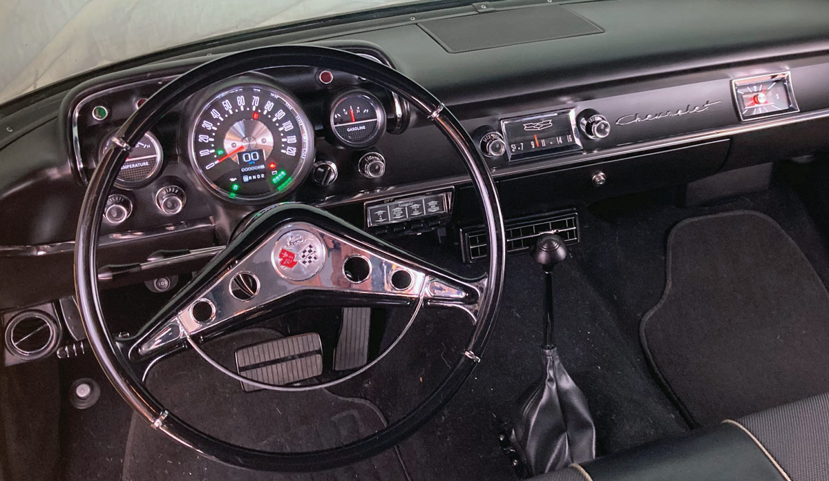 Fully restored 1957 Chevy interior with modernized digital gauges and classic design elements