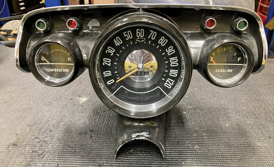 Fully restored and assembled 1957 Chevy gauge cluster with temperature, speedometer, and fuel gauges