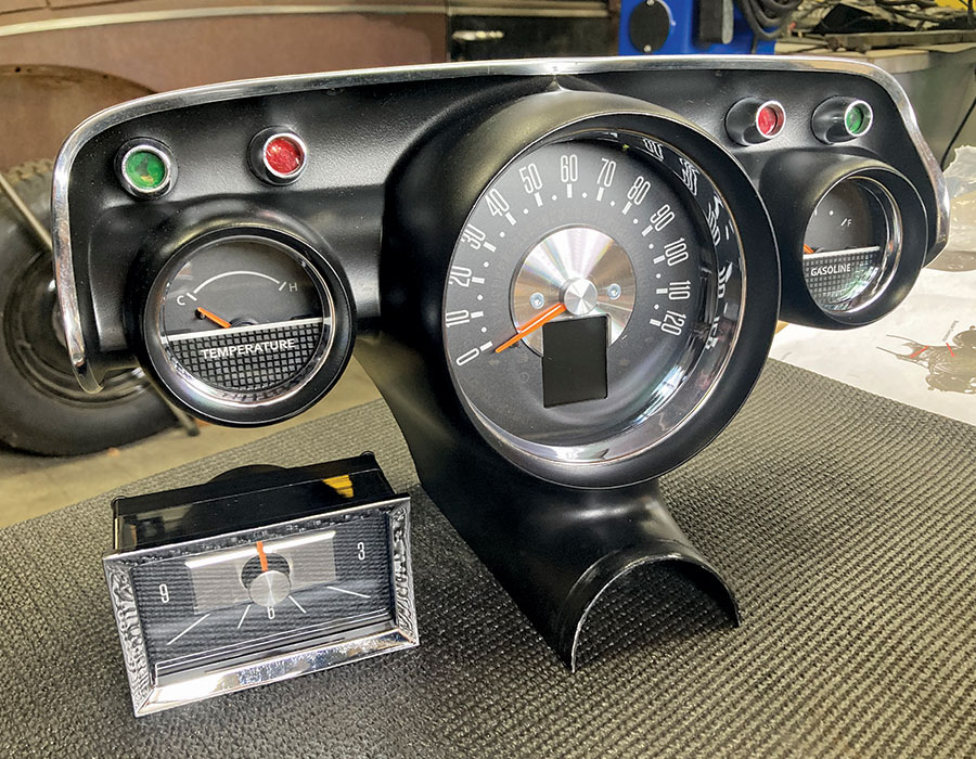 Final assembly of the 1957 Chevy dashboard with a restored clock and gauges installed