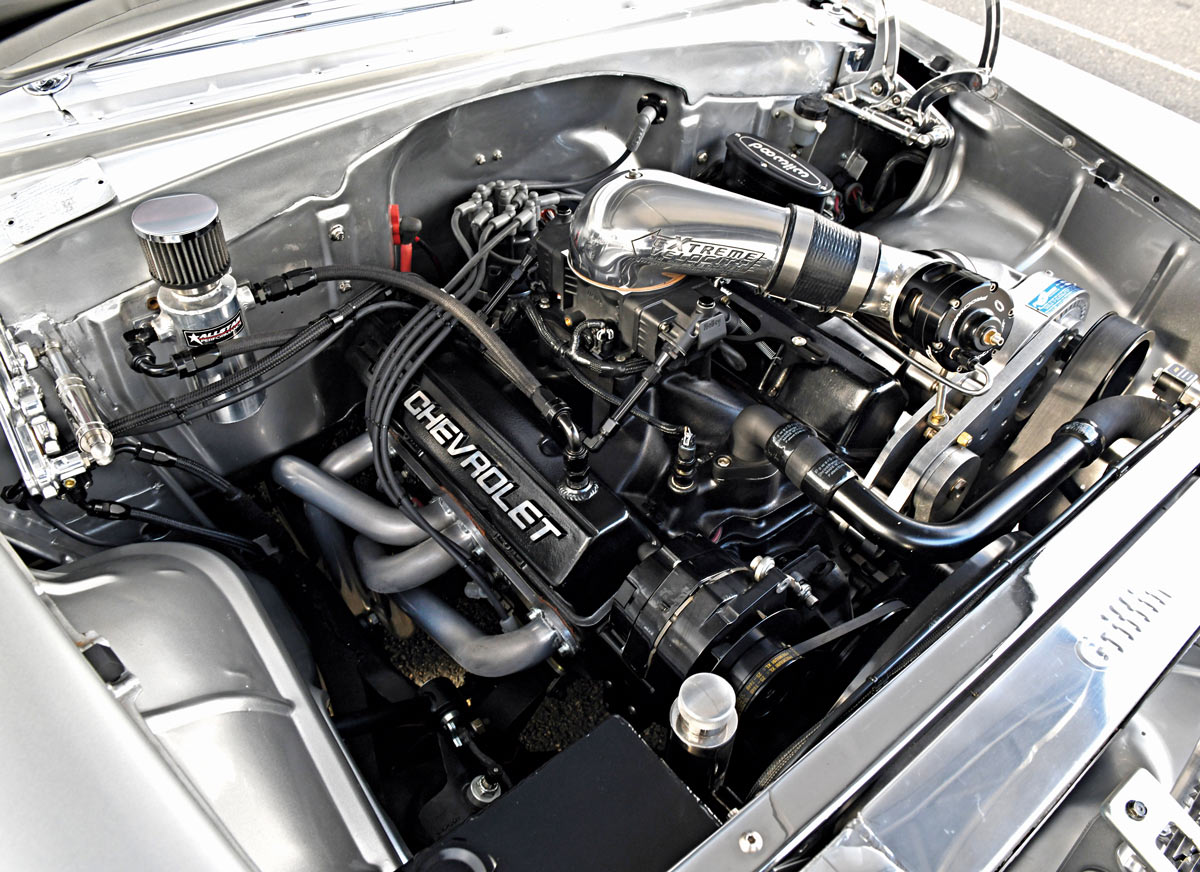 Close-up of the 1955 Chevy Bel Air's engine bay, featuring a ProCharger supercharger and detailed components