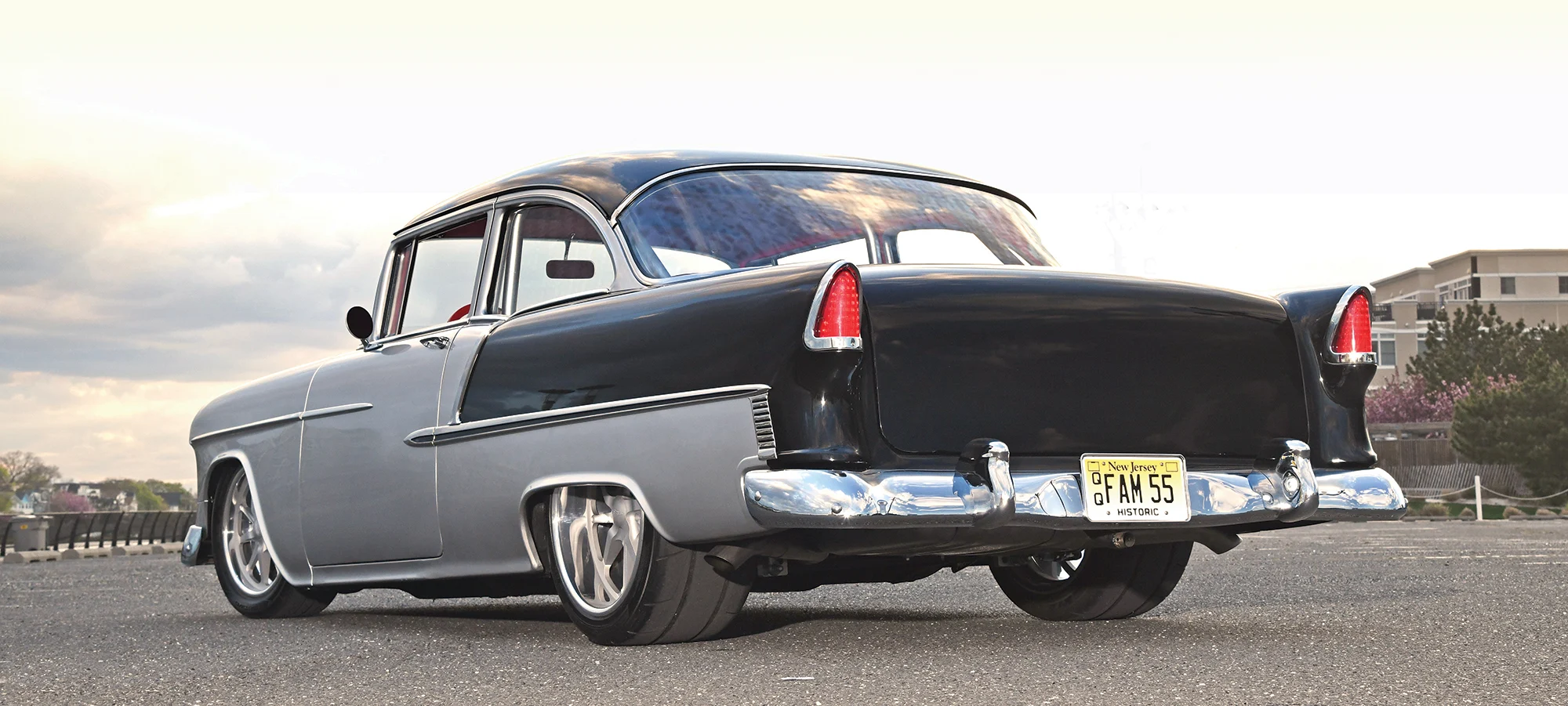 Rear view of a 1955 Chevrolet Bel Air, highlighting its smooth tailfin design and dual exhaust