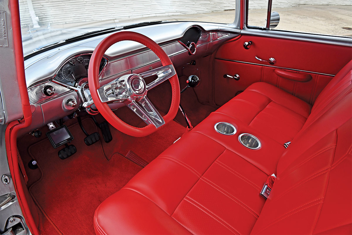 Interior view of the 1955 Chevy Bel Air featuring a custom red leather interior with chrome accents