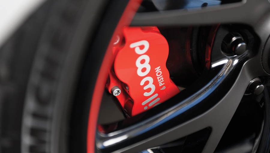 Close-up of the Wilwood six-piston brake caliper behind custom black wheels on the 1969 Camaro Z28