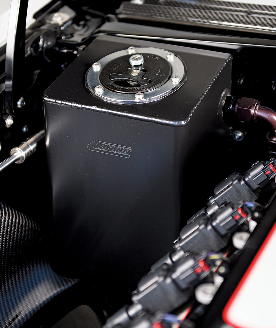 Custom-built black anodized coolant reservoir in the 1969 Camaro Z28's engine bay