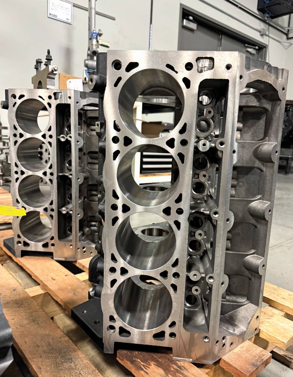 Multiple BluePrint engine blocks on a pallet, with emphasis on the precisely machined cylinders