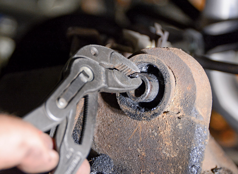pliers removing rubber from bushing