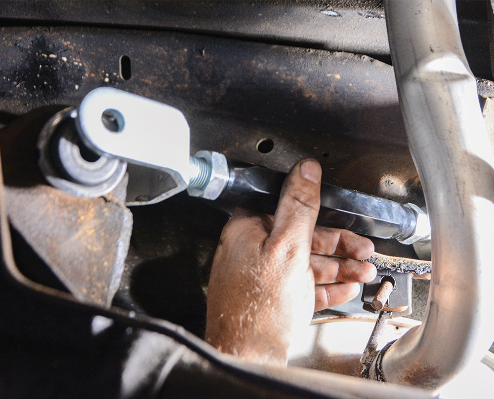 new upper control arm being installed