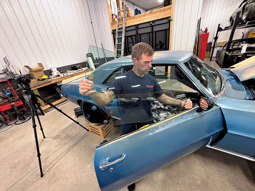 man inserting window glass between doorskins