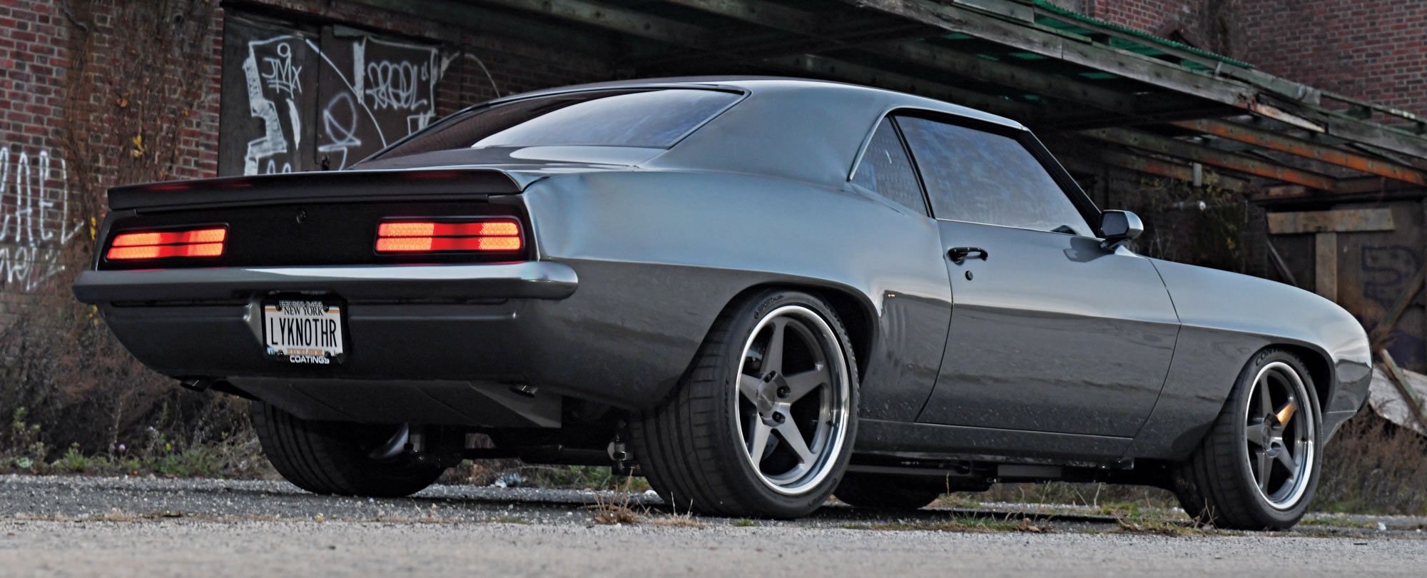 1969 Chevrolet Camaro rear view, smoked taillights, aggressive stance, wide performance tires