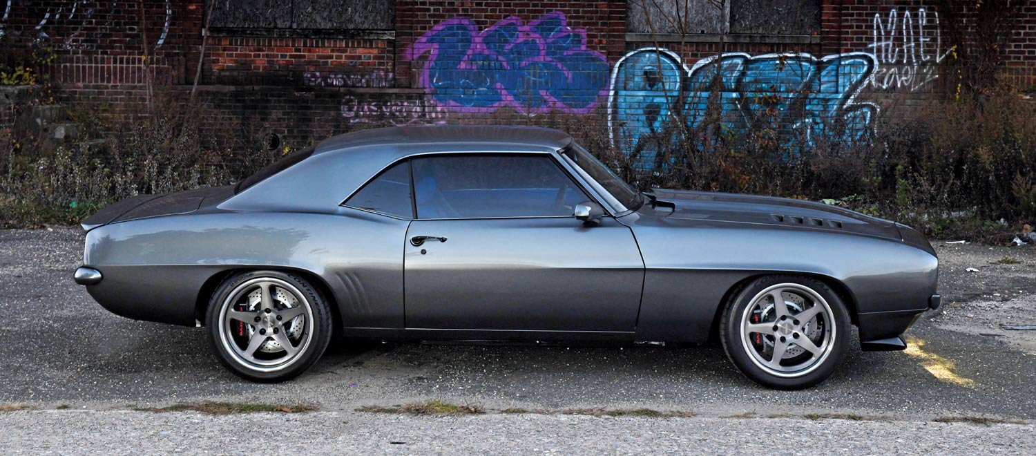 1969 Chevrolet Camaro side profile, lowered stance, five-spoke wheels, classic muscle lines