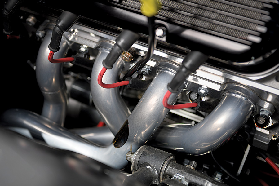 Shot of the 1971 Chevrolet Nova’s headers and wiring, with polished performance components