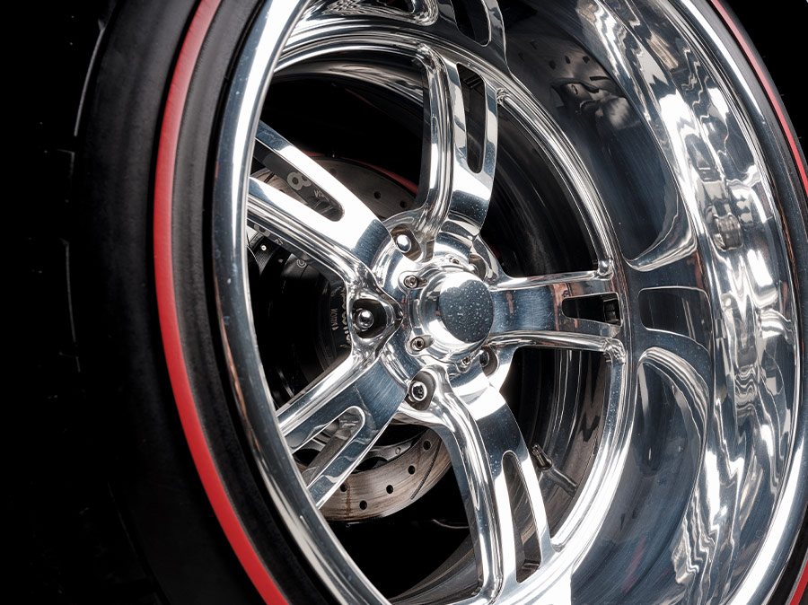 Chrome wheel close-up with red line tires on 1966 Corvette