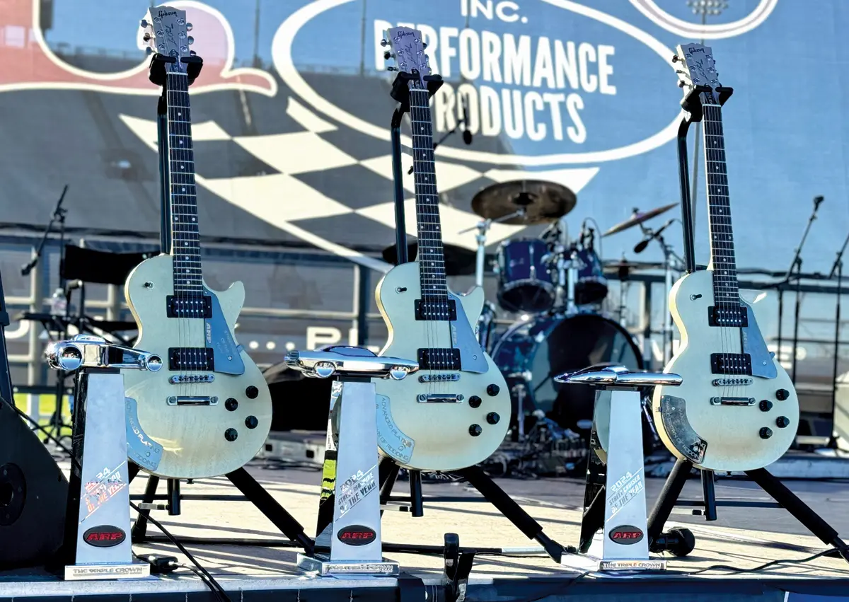 Triple Crown of Rodding 2024 awards featuring custom guitars as trophies on stage
