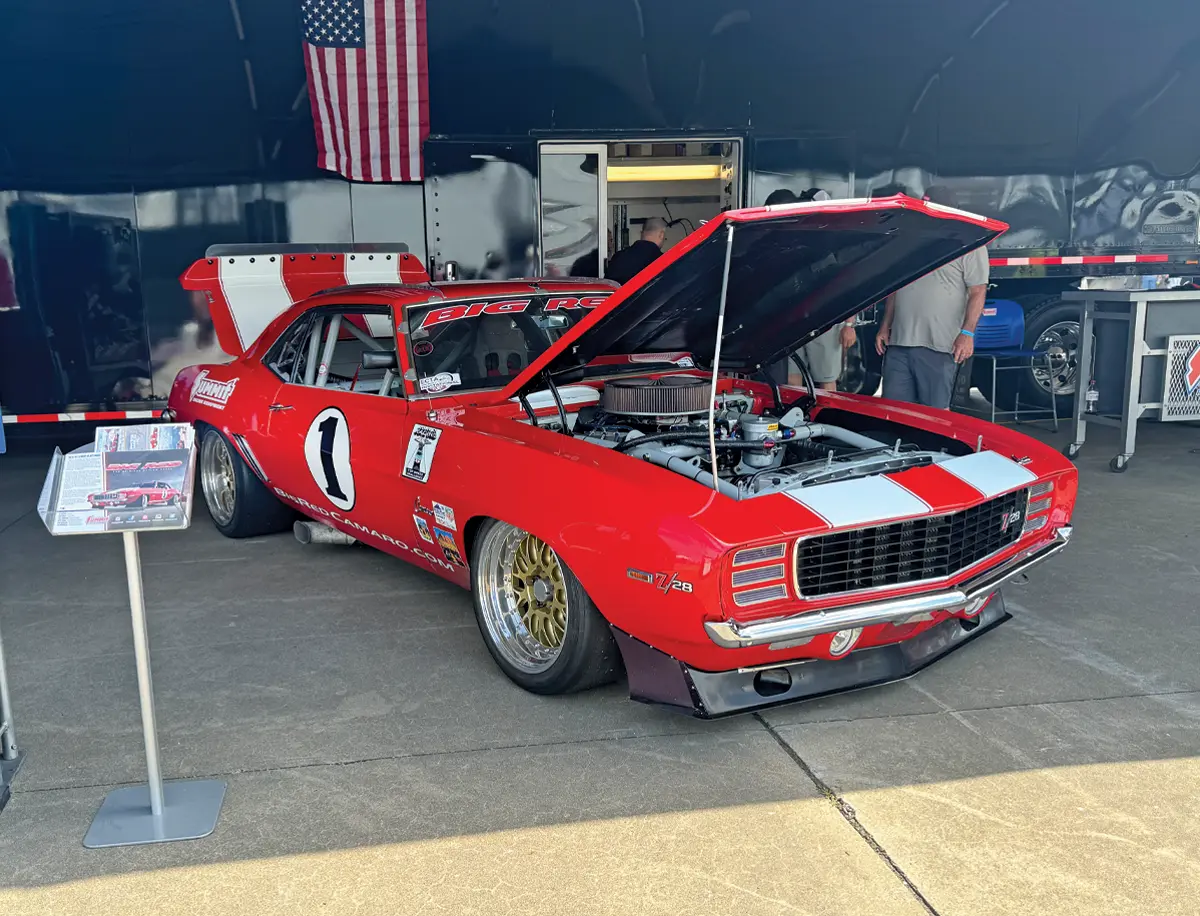 1969 Chevrolet Camaro Z28 race car with widebody and classic red paint at the car event