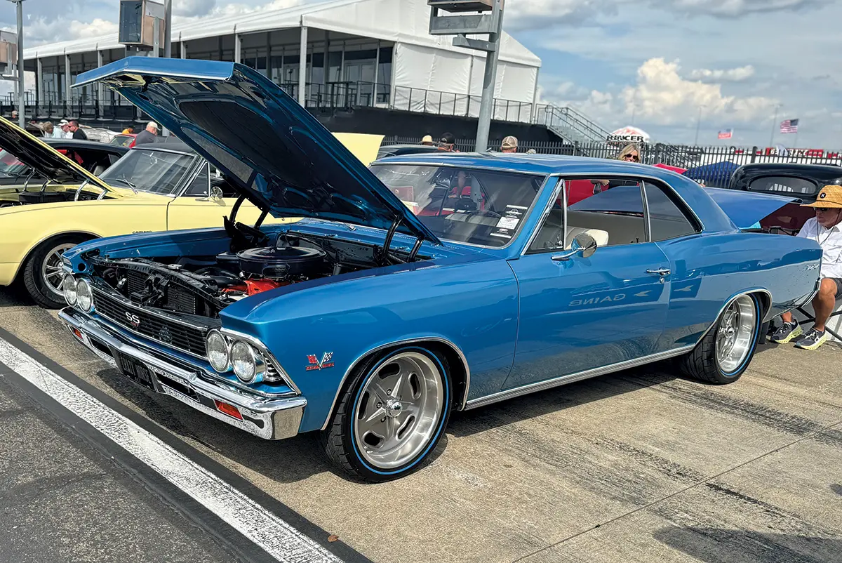 1966 Chevrolet Chevelle SS in blue with open hood showing restored engine at car event