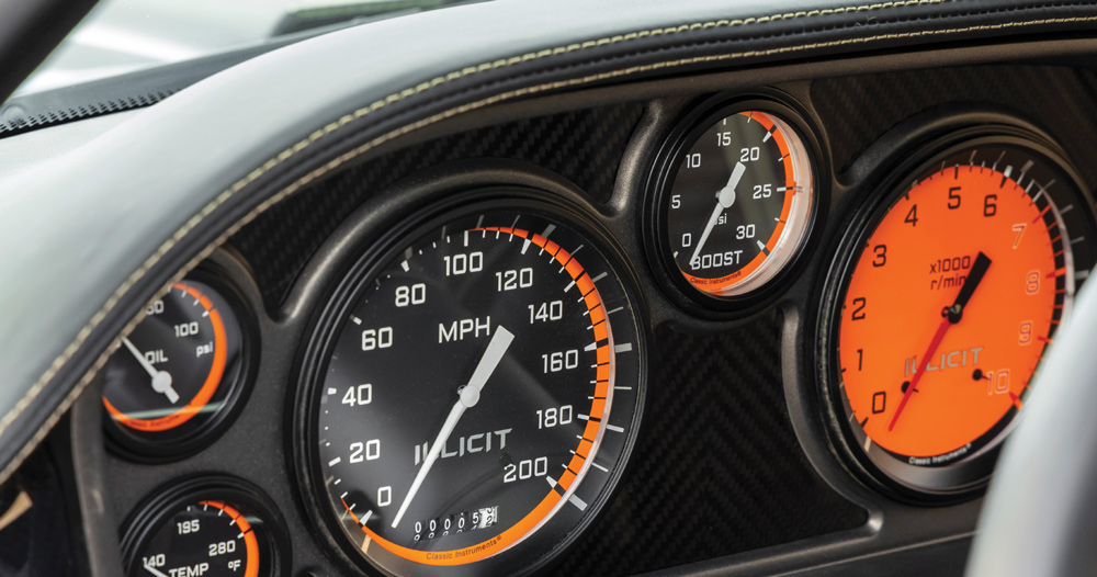 Custom gauge cluster in 1969 Camaro with Illicit branding, featuring speedometer, boost, and tachometer