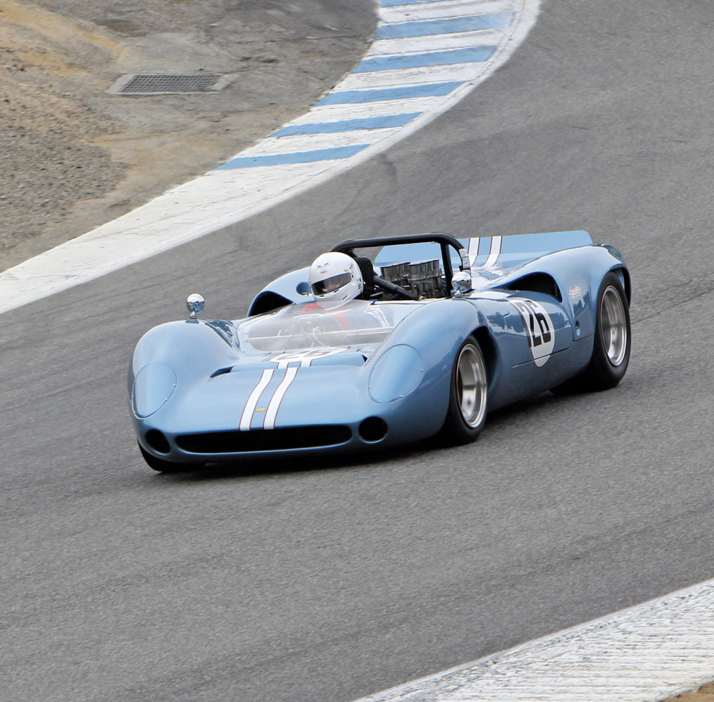 Vintage race car, possibly a Lola T70, on track during a race event