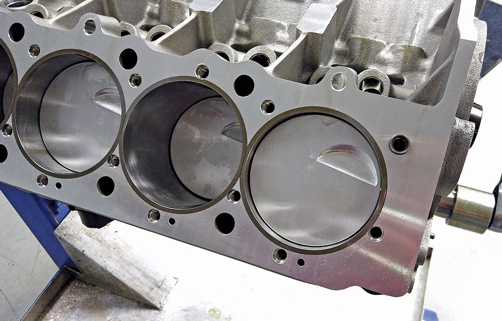 View of the pistons inside a Chevy big block, showing a clean, machined finish